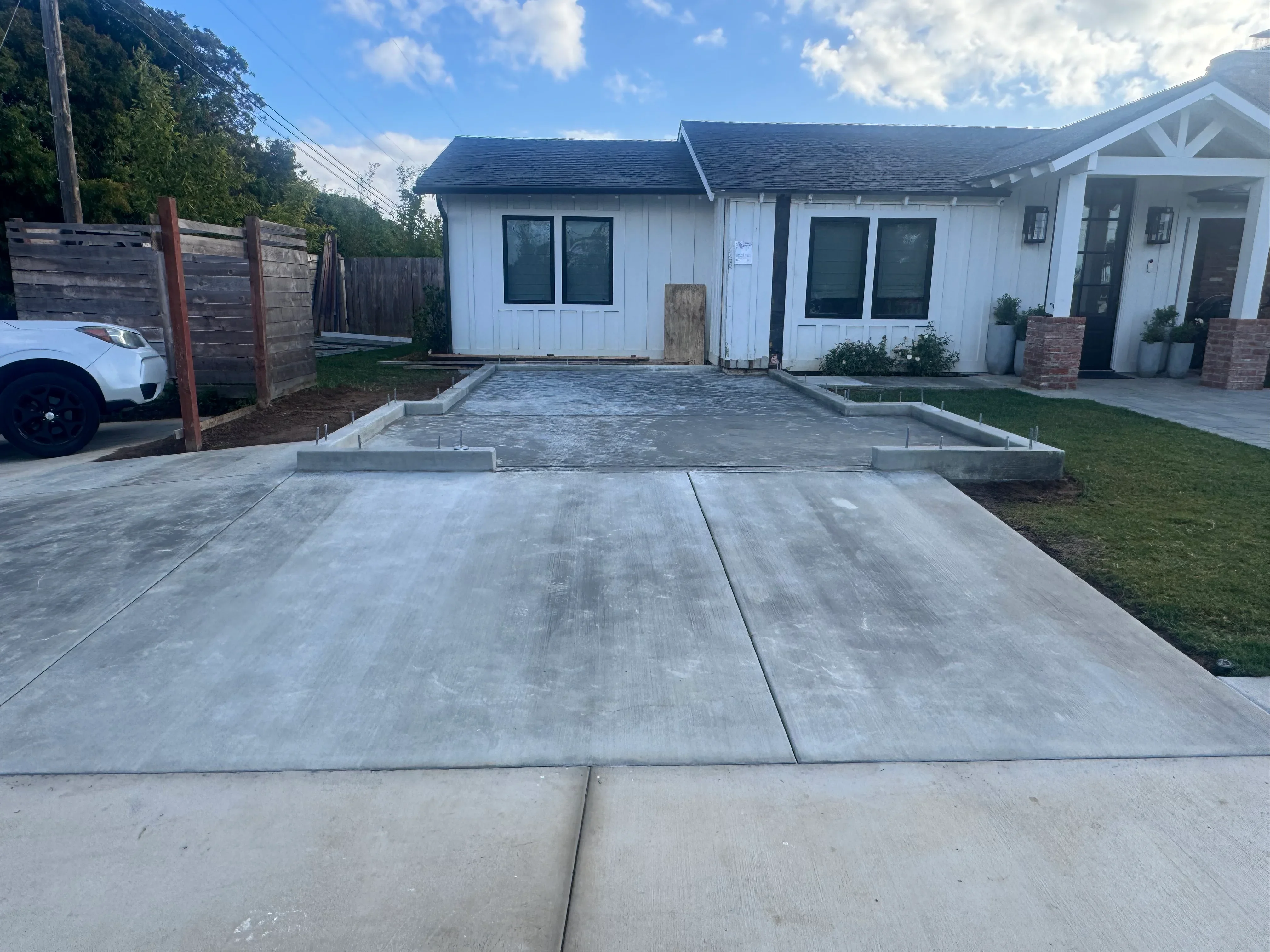 Finished concrete driveway with control joints and concrete curbing installation